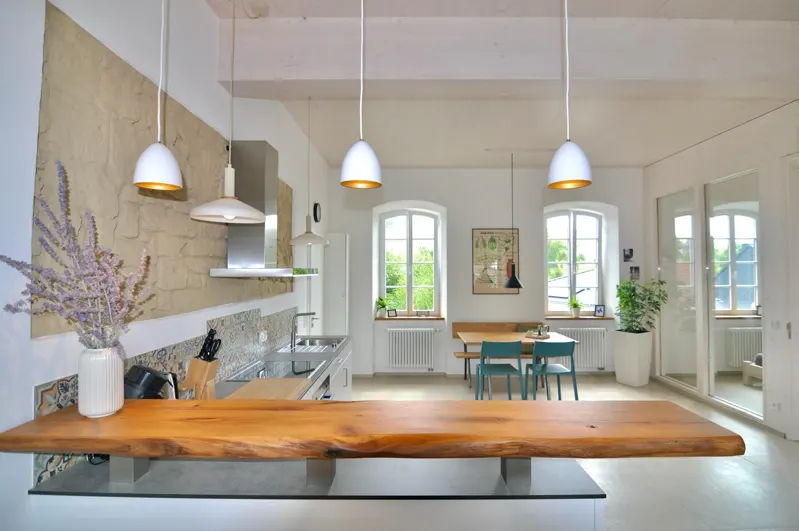 Renovated kitchen with wooden worktop and pendant lights