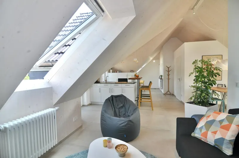 Attic living area with a roof window and sloped ceiling