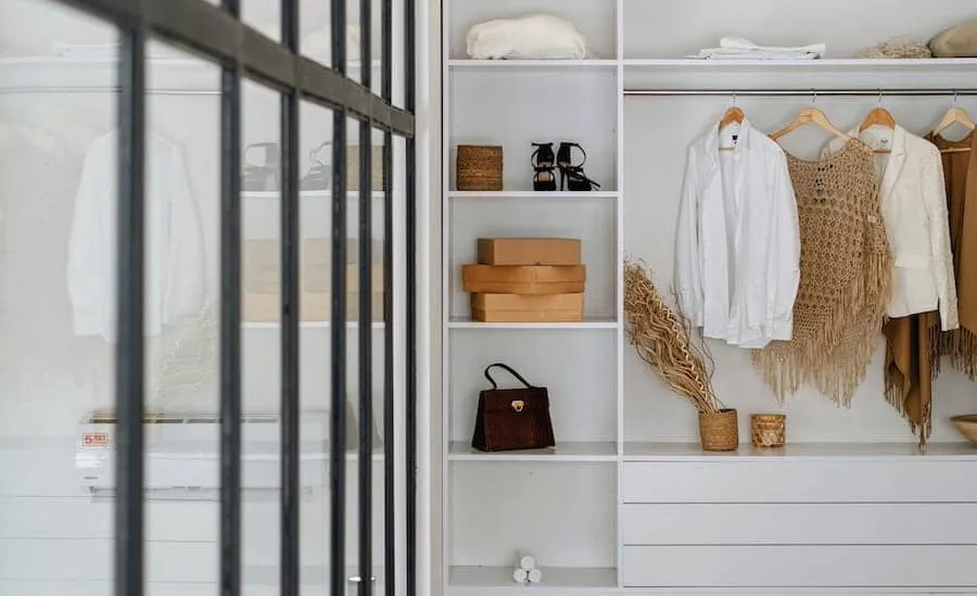 Built-in wardrobe with open shelving, hanging rails and drawers.