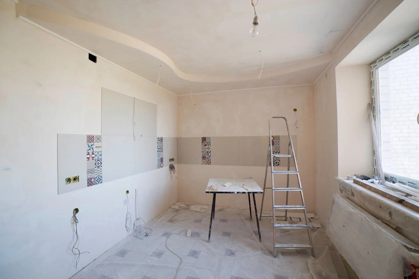 Room stripped back for renovation, with a ladder (stock photo)