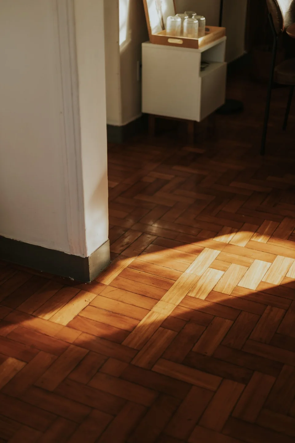 Herringbone parquet in a sunlit room (stock photo)