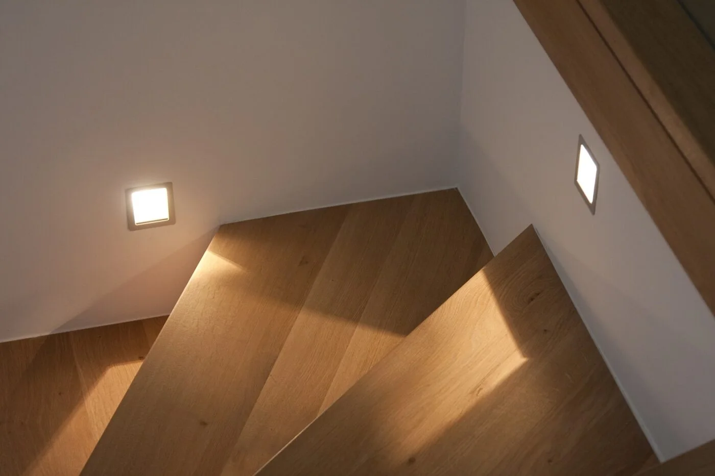 Recessed lighting along a wooden staircase