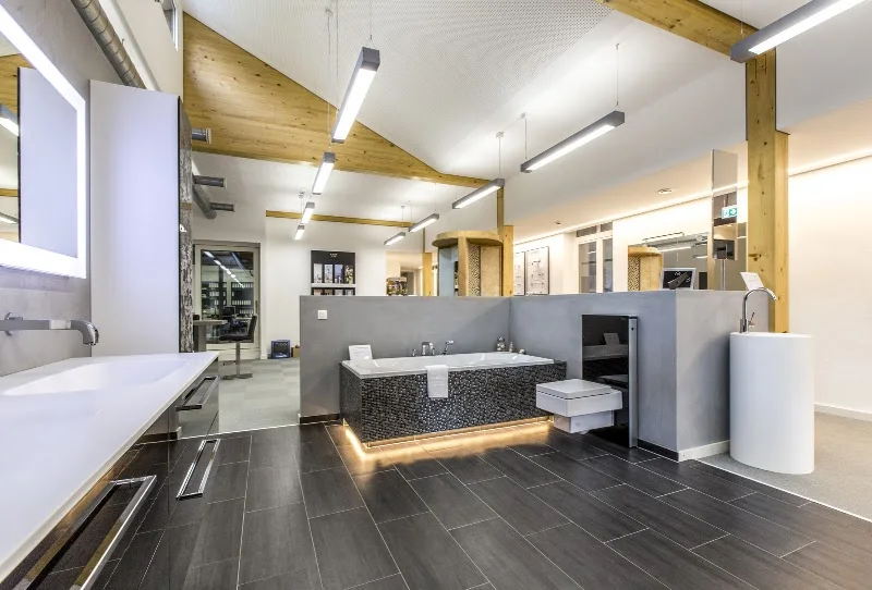 Showroom with bathroom furniture and tile displays under the steelworks roof