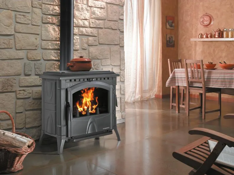 Freestanding wood stove burning in a living room.