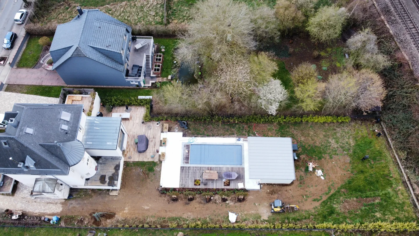 Pool under construction behind a house, seen from above