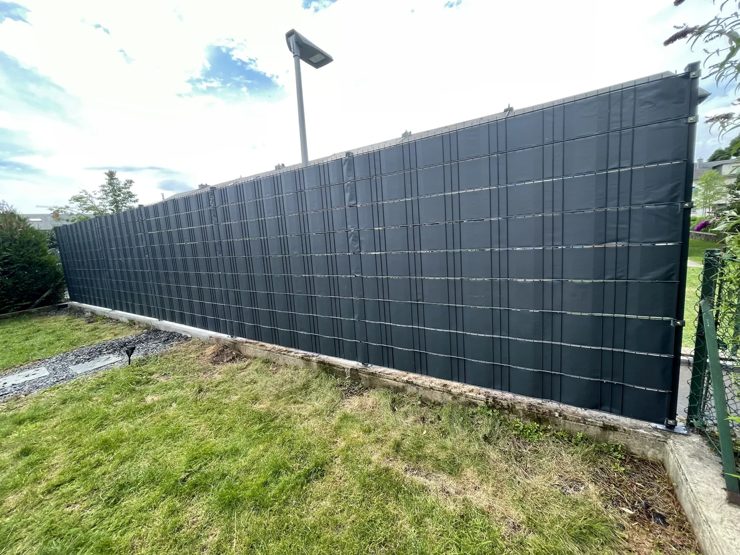 Privacy screen fence along a garden