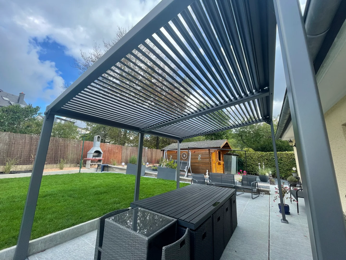 Louvred pergola over an outdoor kitchen and terrace