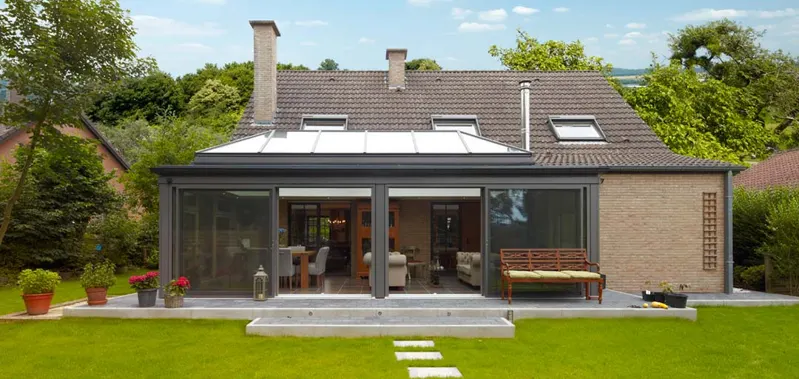 House with several roof windows and a glazed rear extension.