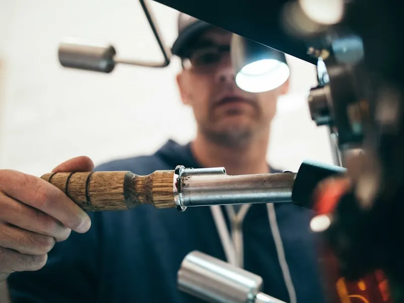 Portrait of a worker using a hand tool.