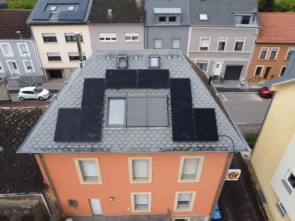 Panels on the slate roof of a terraced house
