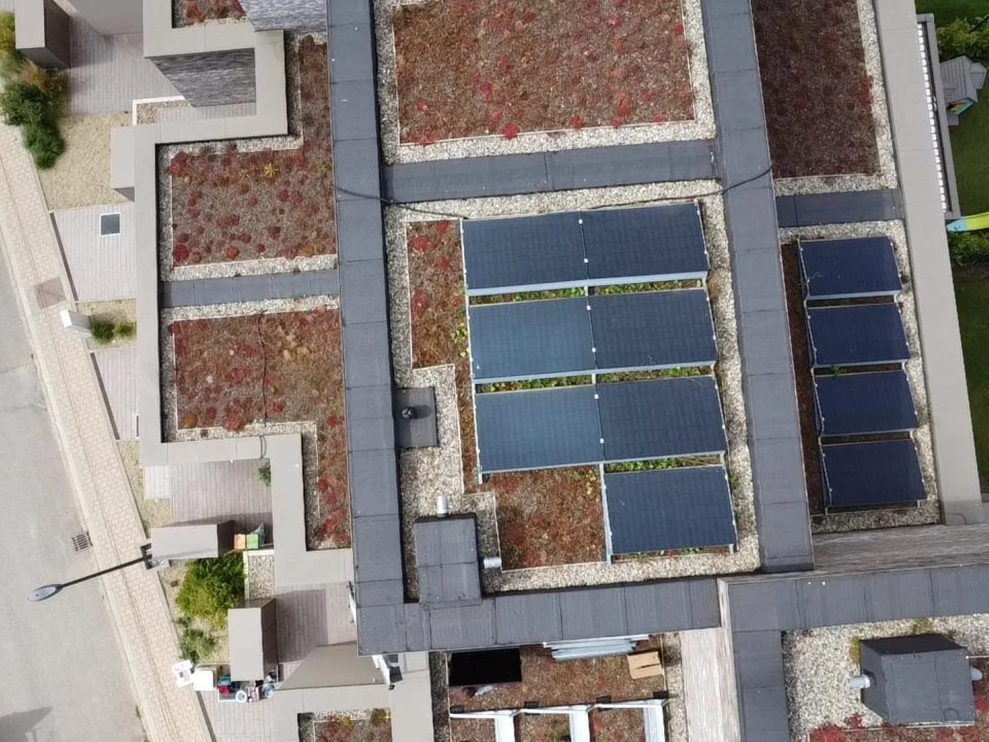 Flat roofs of an apartment building with panels, aerial view