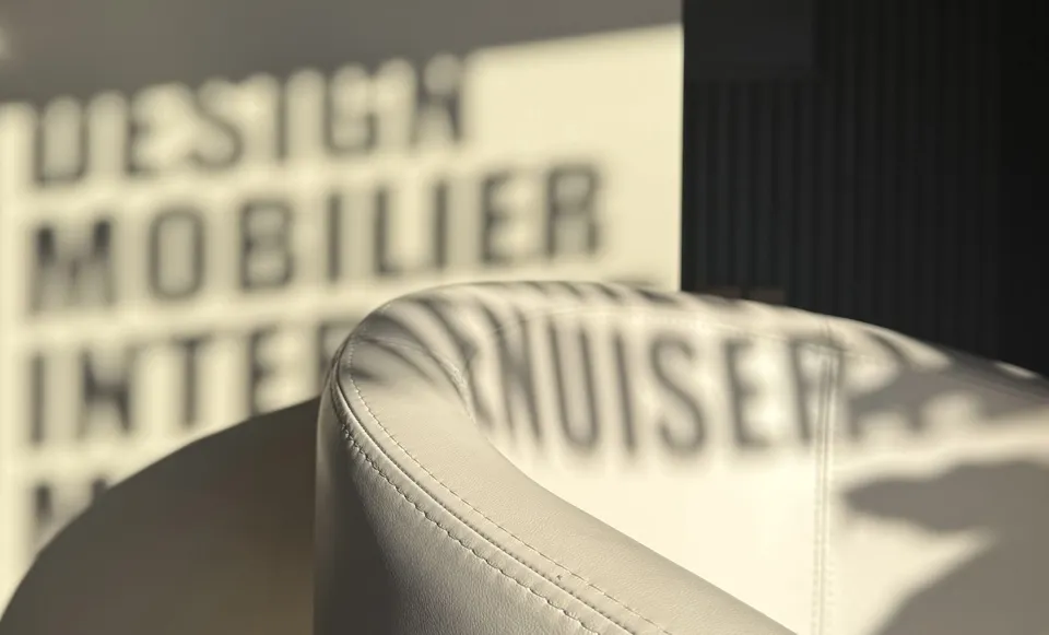 Close-up of a light upholstered chair with projected lettering.