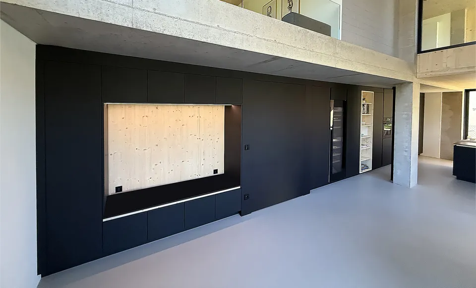 Built-in black cabinetry and storage in a modern interior.