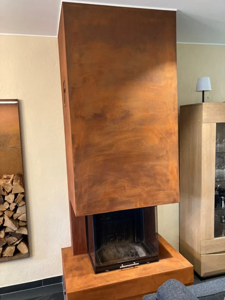 Copper-effect finishing render on a fireplace hood