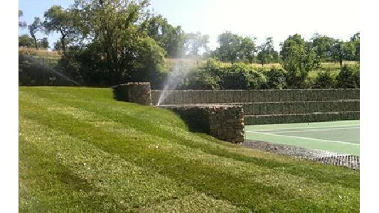 Sports ground with lawn and a tennis court