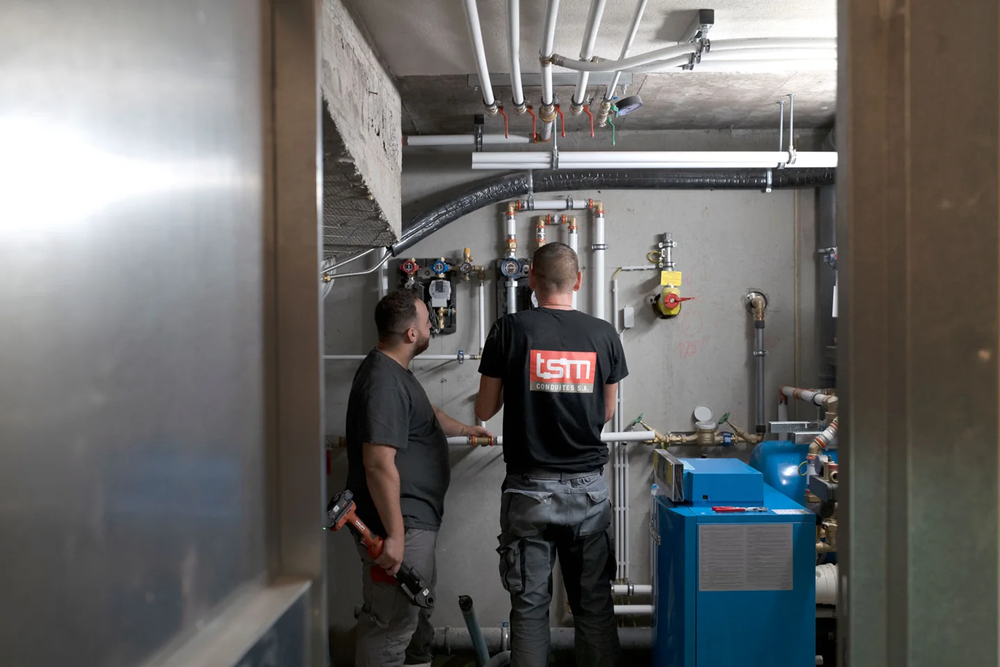 Two technicians at work in a plant room