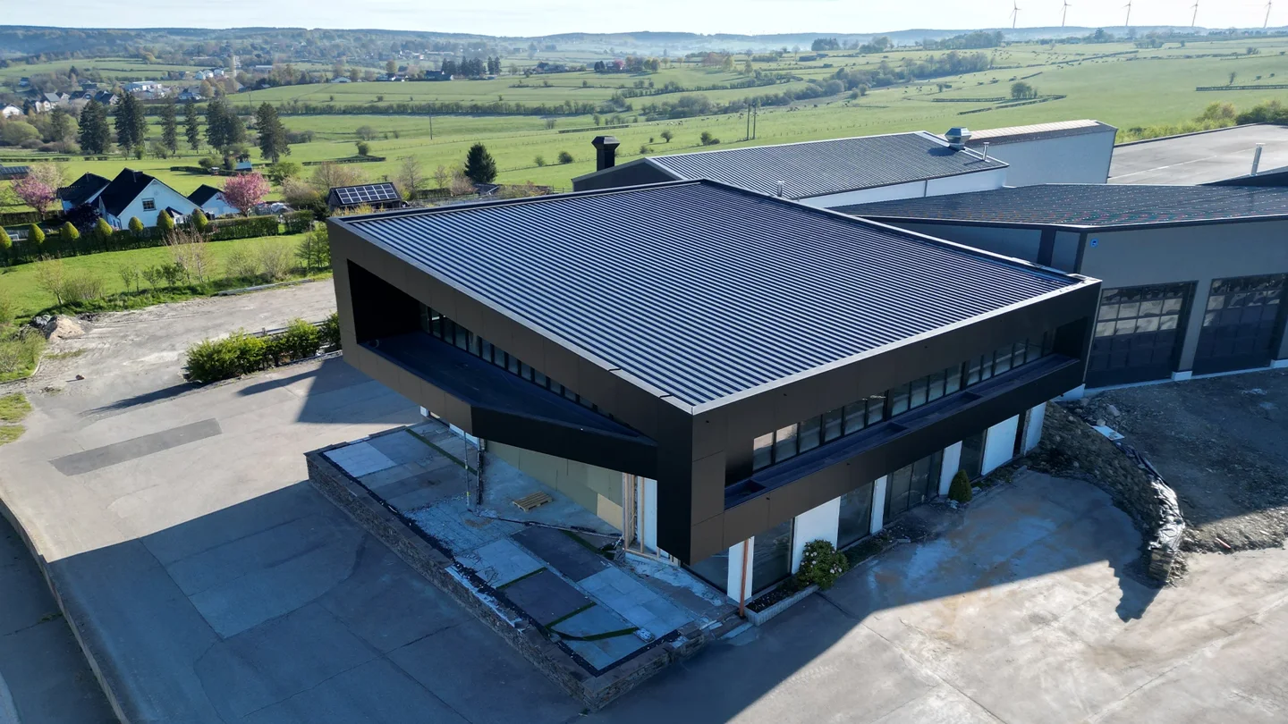 Showroom rebuilt in timber with a flat roof and dark Trespa façade