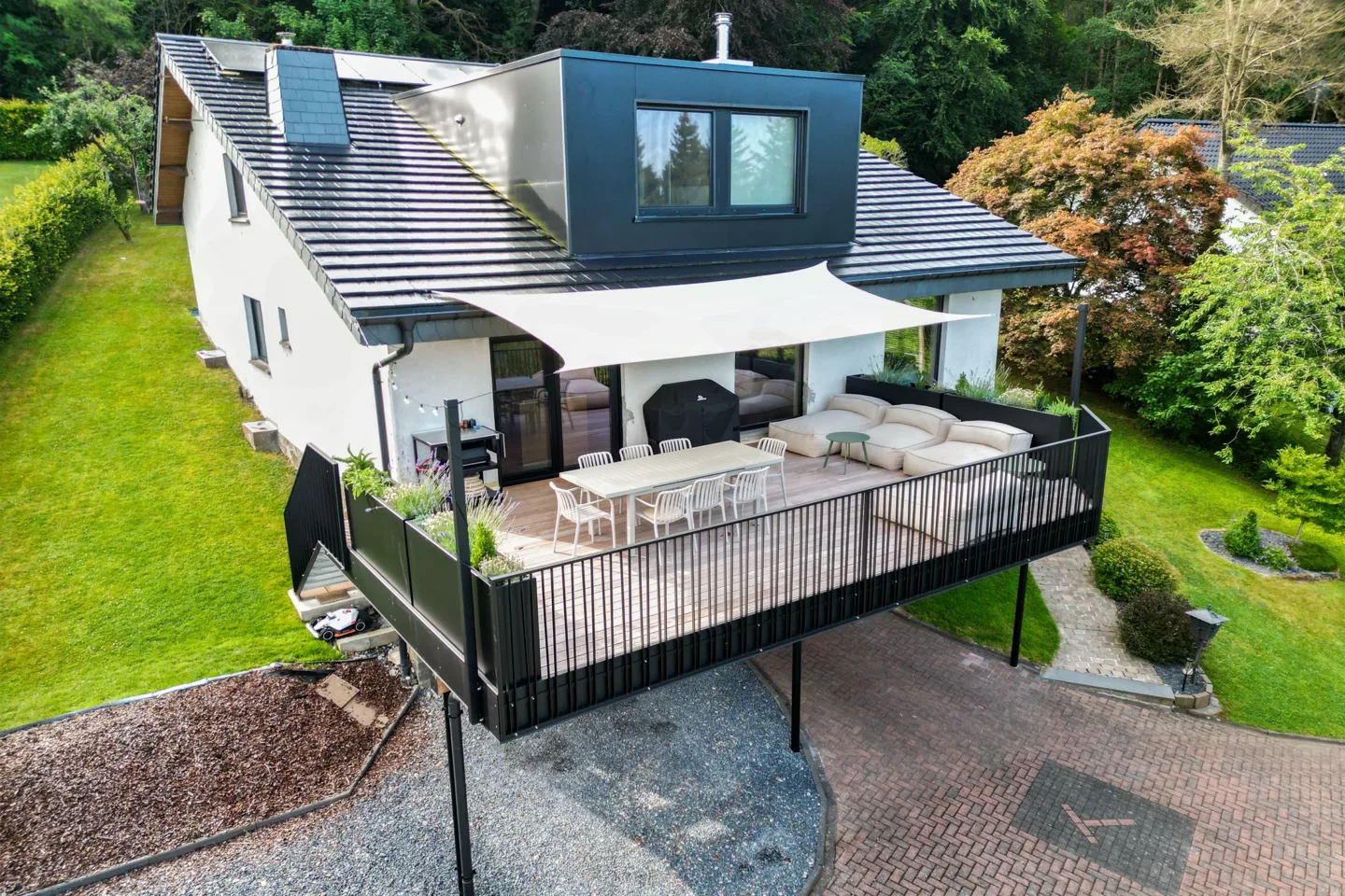 Terrace on a steel-and-timber structure that doubles as a covered carport
