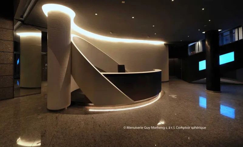 Curved illuminated reception counter in a modern interior.