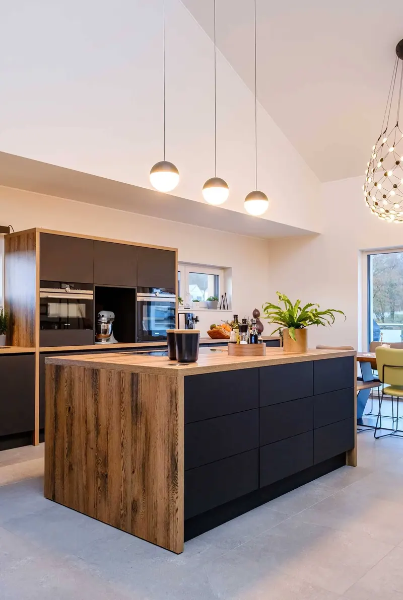 Kitchen island with wood paneling and dark drawers.